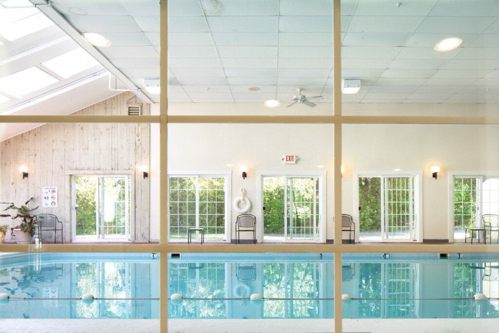 viewing the indoor pool through a window at Country Inn - hotel in camden maine