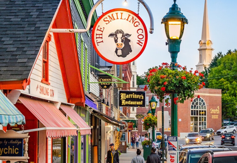 Shopping Camden Maine - The Smiling Cow storefront sign in summer